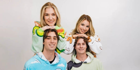 two couples wearing blanket hoodies